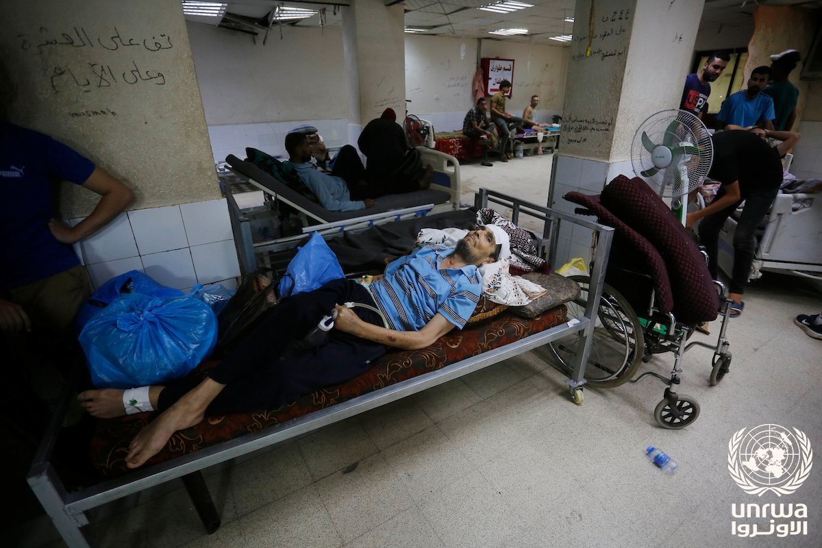 Patients on hospital beds awaiting evacuation inside Al-Aqsa Martyrs Hospital
