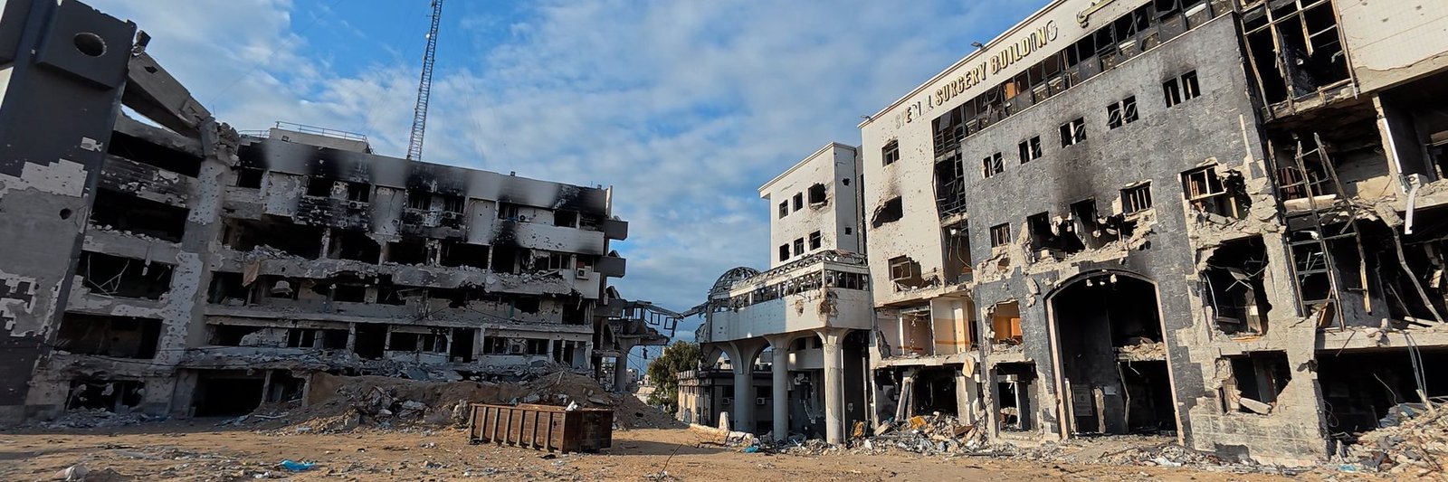 The burnt-out blocks of Al-Shifa Medical Complex, with the gutted special surgery building on the right and a cleared, rubble-strewn forecourt